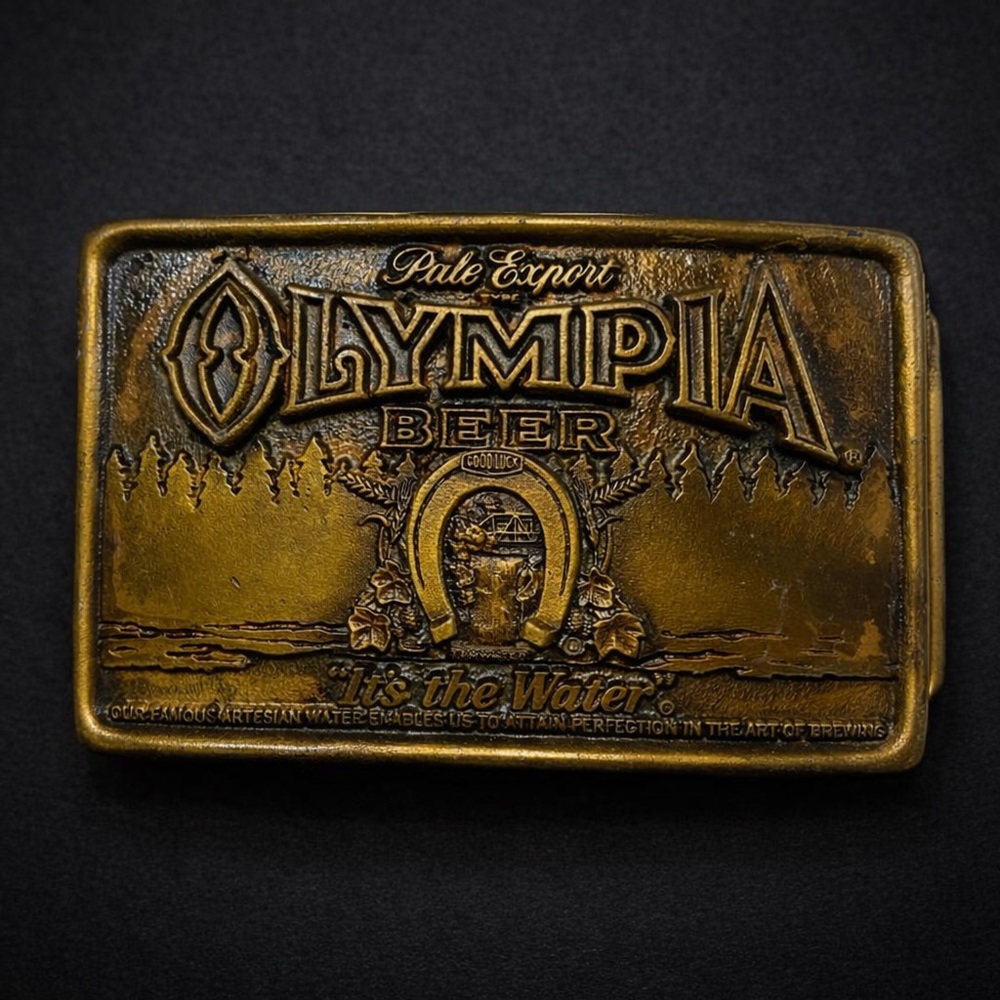 Vintage 1977 Olympia Beer Belt Buckle Brass Tone “It’s The Water” Breweriana